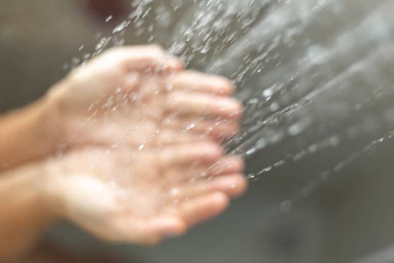 water poured into hands Photo By Anderson Coelho at istock