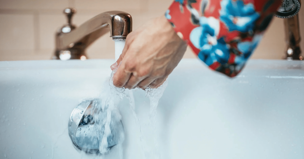 a person washing hands under a faucet